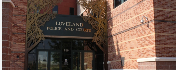 Beautiful rust brick building with brown glass doors.