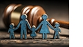 Wooden family cutouts on table in front of a gavel.