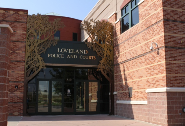 Beautiful rust brick building with brown glass doors.